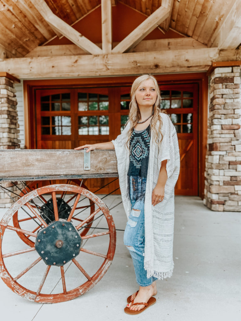 a blonde girl in front of a small town Inn with a navajo necklace on a turquoise jewelry pieces