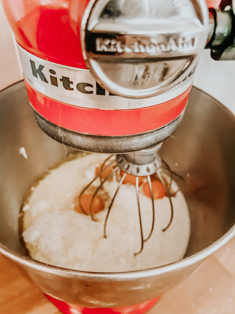 a red kitchenaid mixing the ingredients