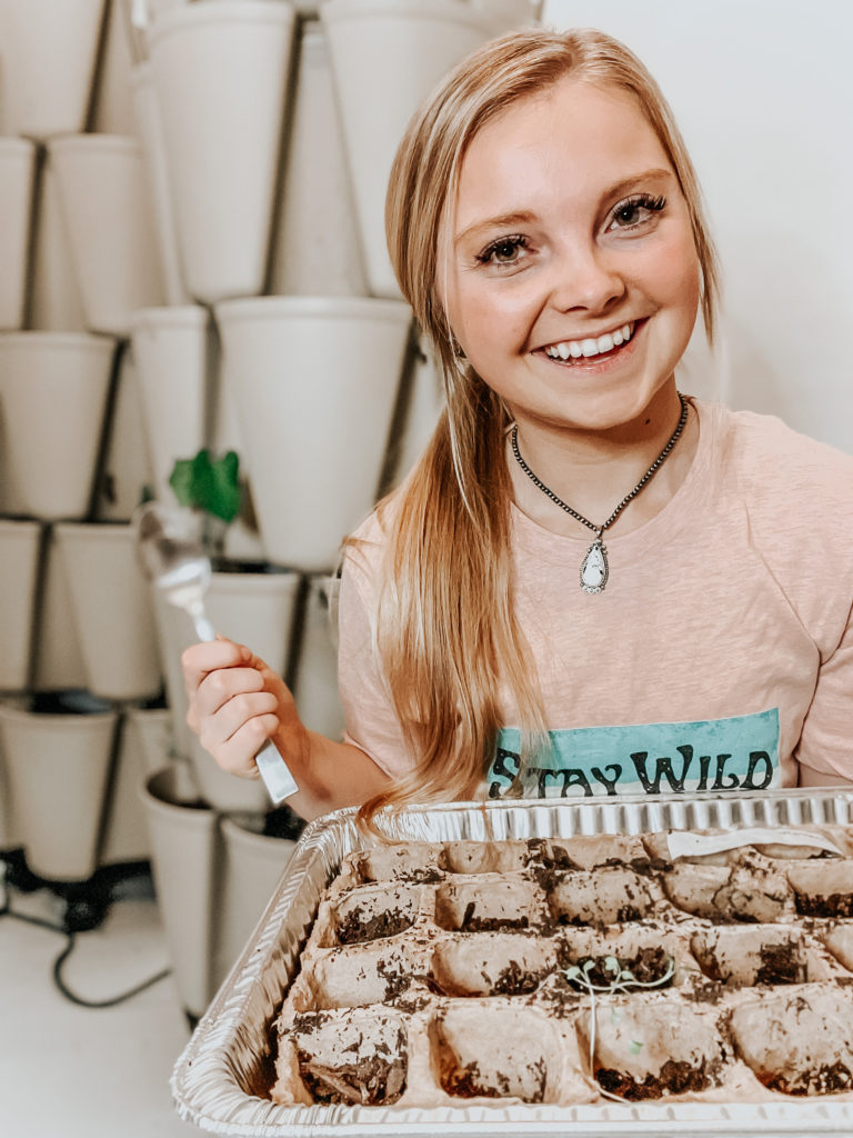 kiersten zile with brown seed trays germinating seeds with a spoon