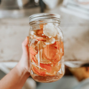 a jar of fruit vinegar with orange peels in it