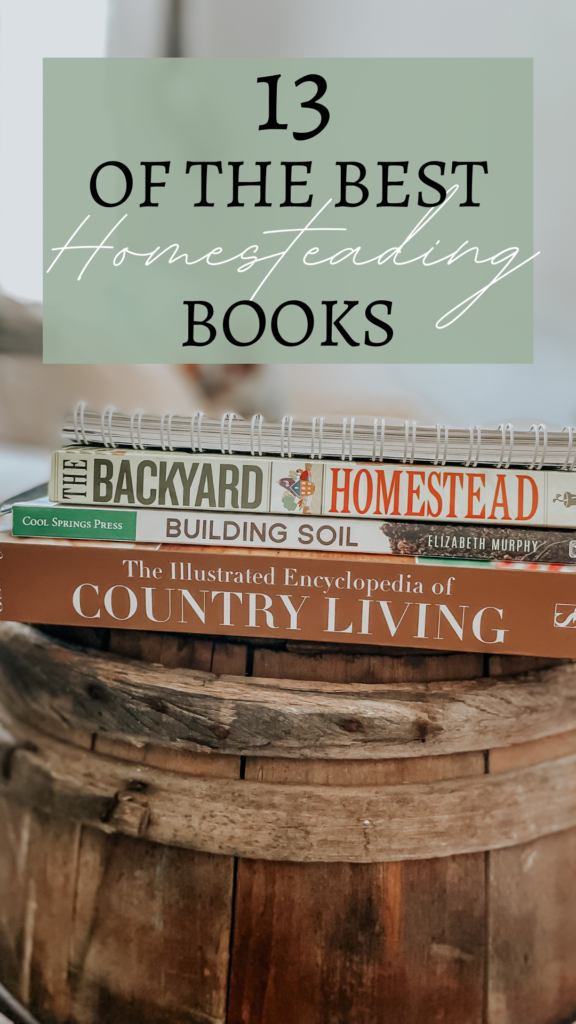 a stack of best homesteading books on a wood barrel in a bright white living room