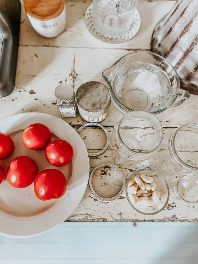 tomatoes with tools and ingredients to ferment tomatoes for preserving