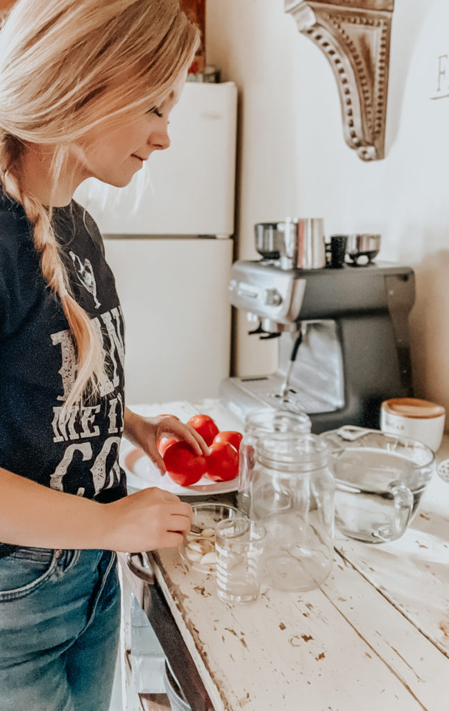 kiersten zile setting up supplies to ferment tomatoes