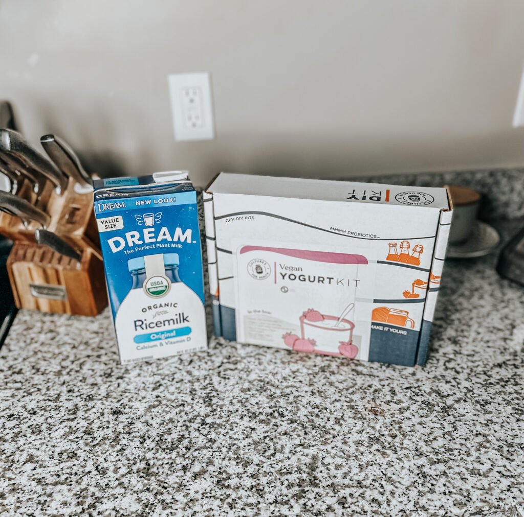 a dairy-free yogurt kit with organic rice milk sitting next to it on a granite counter top