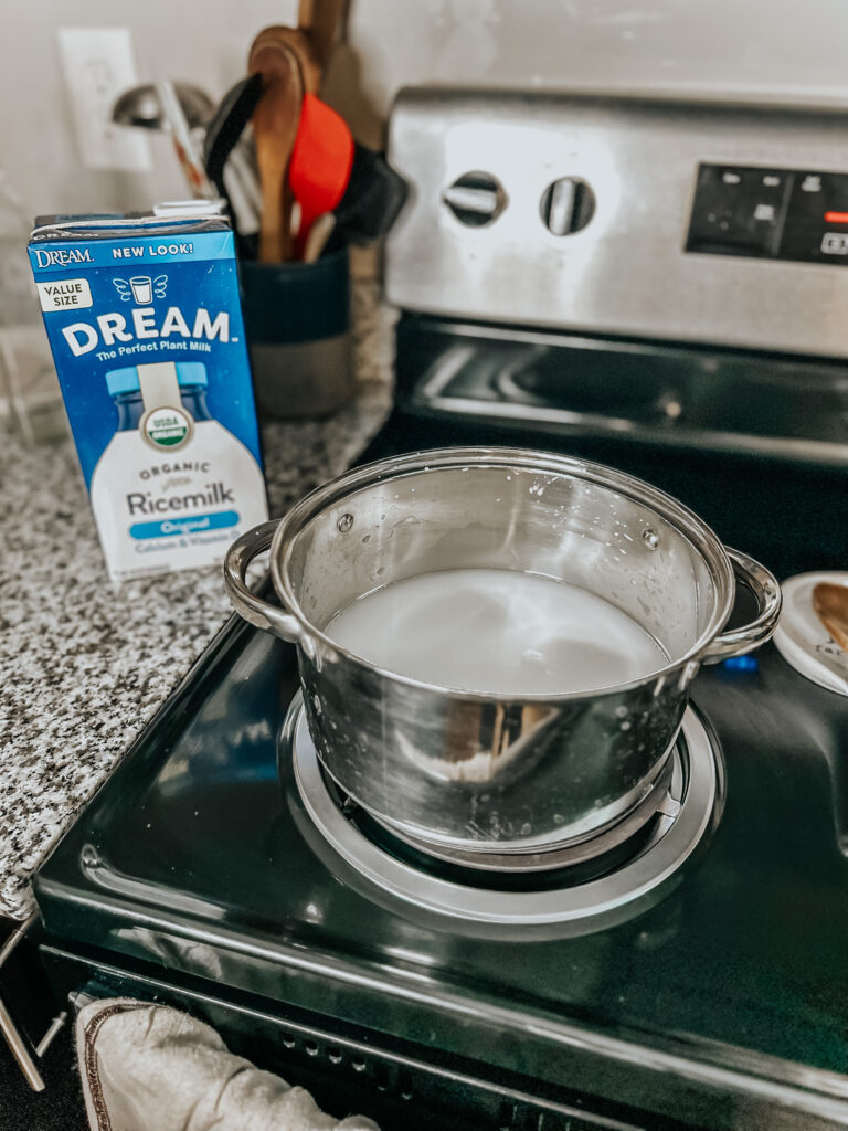 organic rice milk in a pot on the stove heating up to make dairy-free yogurt