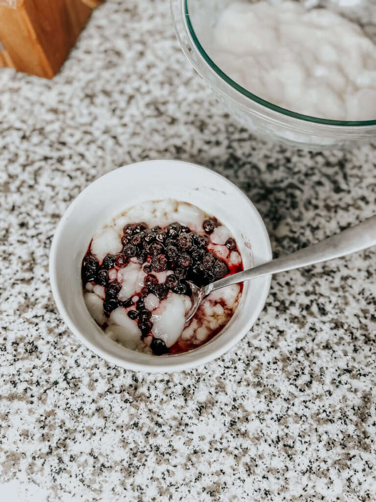 the finished dairy-free vegan yogurt with maple syrup and blueberries before it is blended