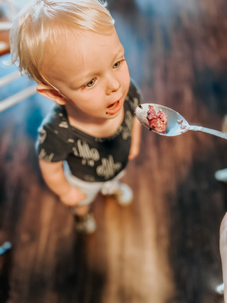 a toddler eating the finished dairy free yogurt