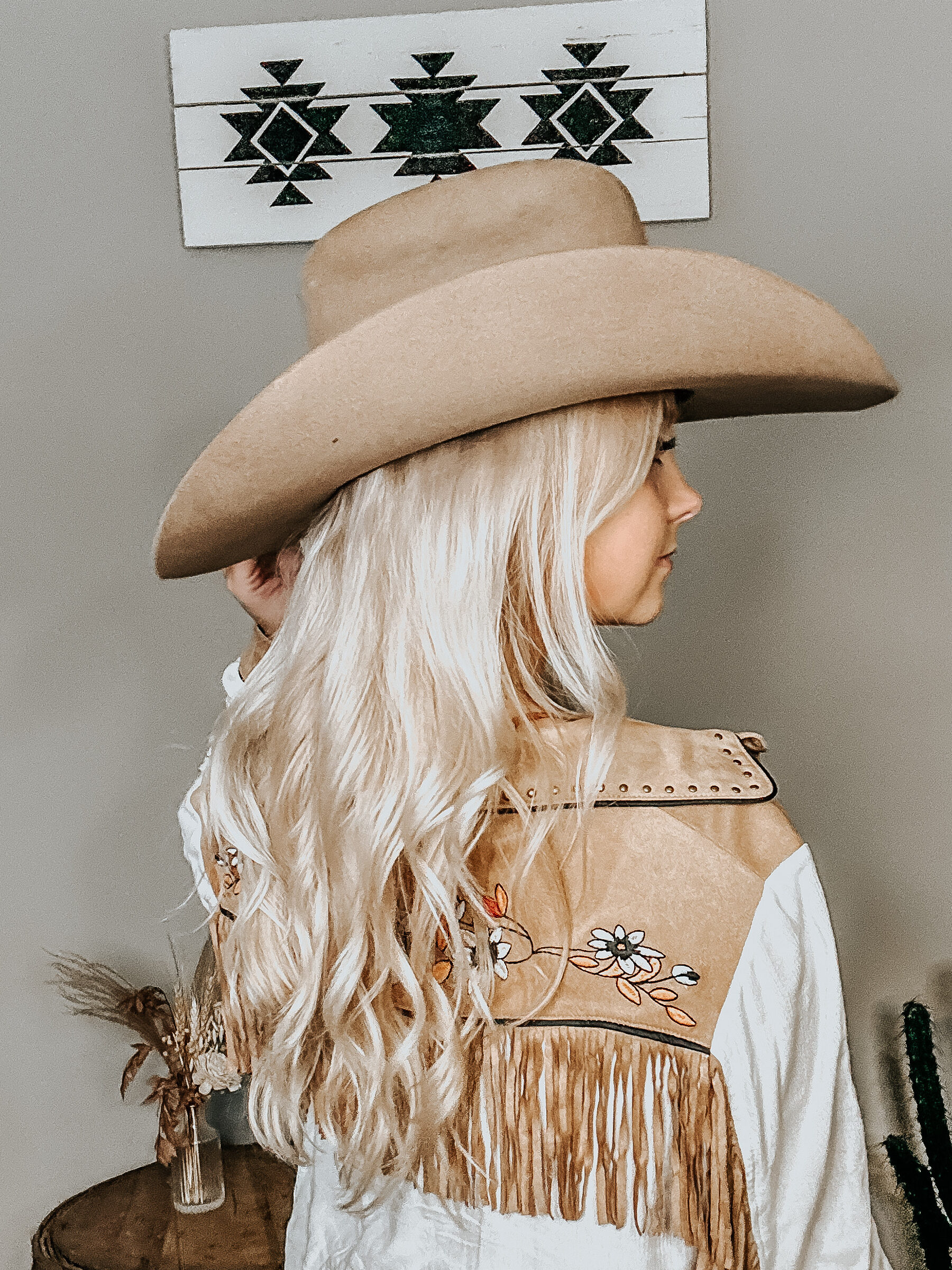 kiersten zile with a fringe western button-up back view of it to show the western fall dress style to give a visual of the look with a tan felt cowboy hat on