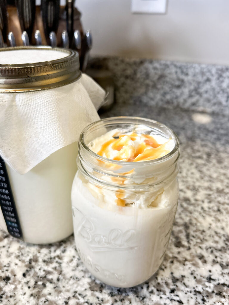 fermenting milk kefir next to a fancy finished milk kefir with whipped cream and caramel syrup