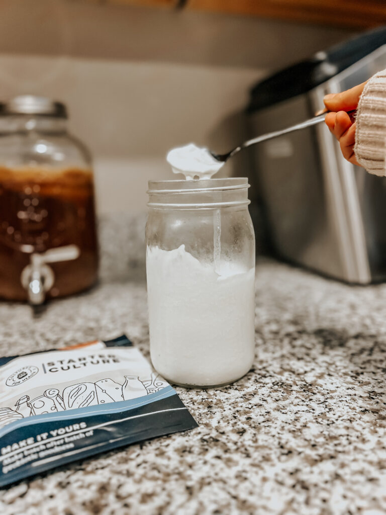 homemade sour cream in a jar with cultures for health packets